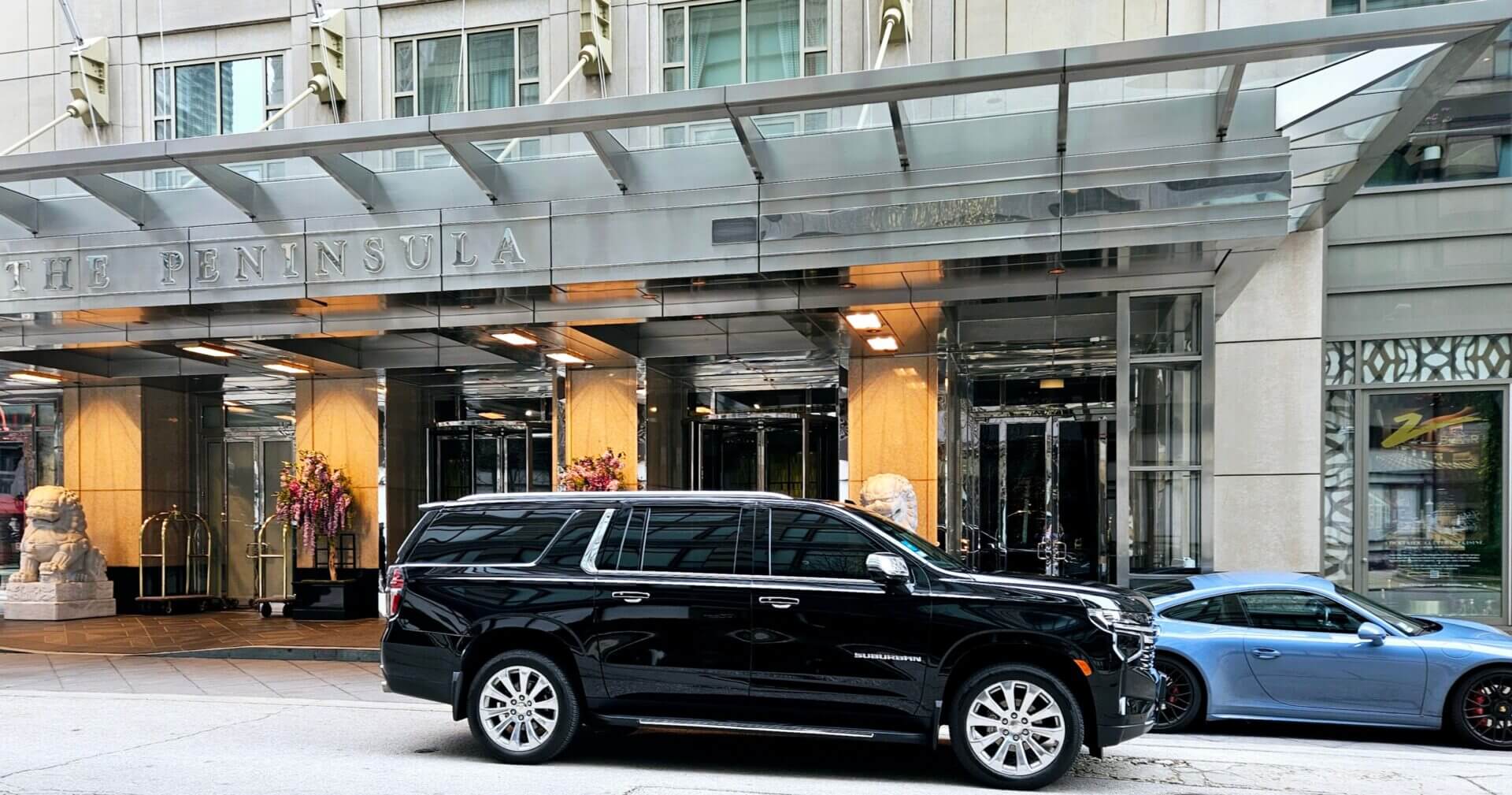 Professional black car service vehicle parked in downtown Chicago, IL.