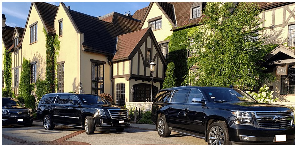 Black SUVs parked in front of houses.